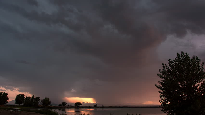 Time lapse of lightning flashing in storm clouds at sunset over Utah Lake.