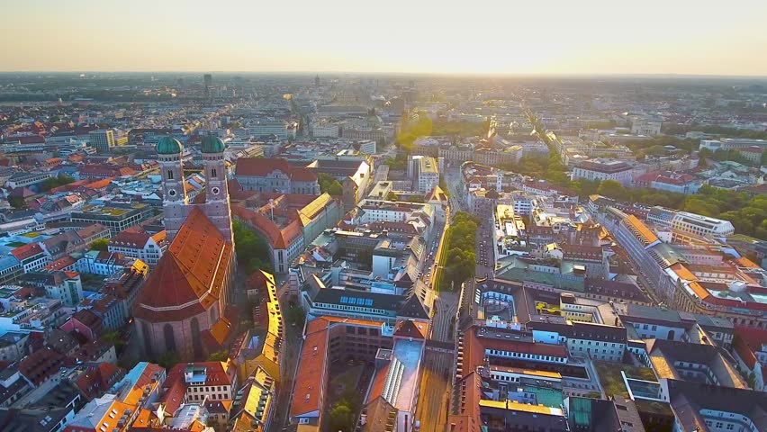 Munich aerial view at sunrise flying over Munich Marienplatz old town view of Frauenkirche (Cathedral of Our Dear Lady) beautiful birds view of Munchen City Bavaria Germany. Royalty-Free Stock Footage #1015583287