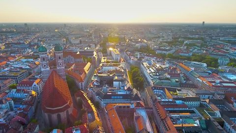 Munich aerial view at sunrise flying over Munich Marienplatz old town view of Frauenkirche (Cathedral of Our Dear Lady) beautiful birds view of Munchen City Bavaria Germany.