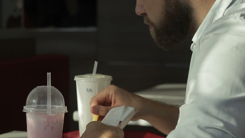 Hungry, sad, single young male having greasy meal in cafe, junk food consumption Royalty-Free Stock Footage #1015584736