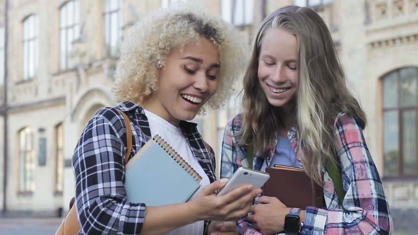 Two young, arrogant female students trolling enemies account at social networks Royalty-Free Stock Footage #1015584760