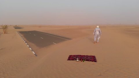 Tuareg man walking in a desert