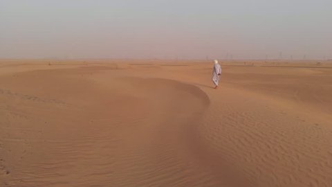 Tuareg man walking in a desert