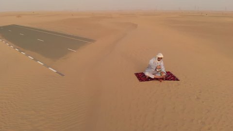 Tuareg man drinking tea in a desert 