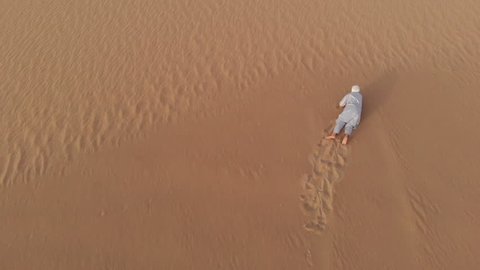 Tuareg man crawling in a desert
