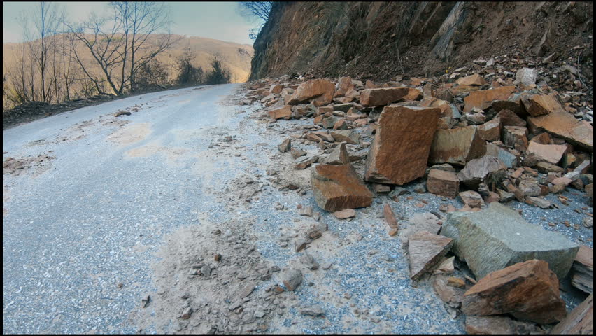 Road landslide. Mud and rocks blocking the road