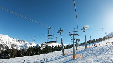 Intersection of ski lifts. Chairlift POV going up a ski resort in Bansko, Bulgaria