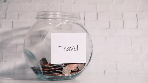 UK Money Jar on a white shelf in a household living room. Saving for Travel Concept