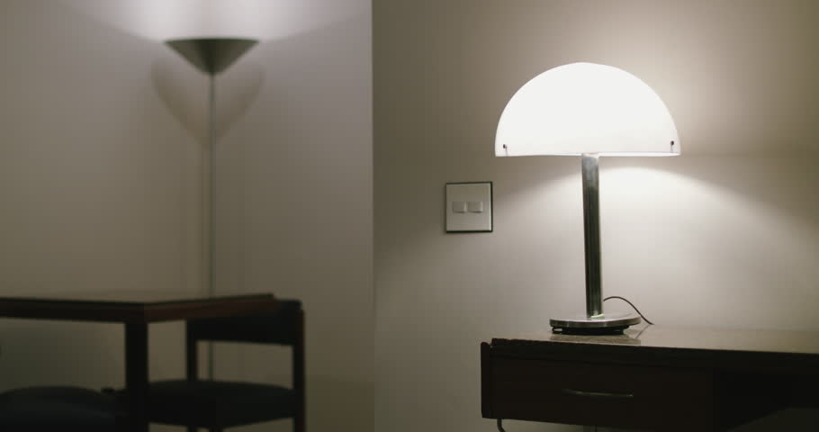 Young man turning lights OFF and leaving home