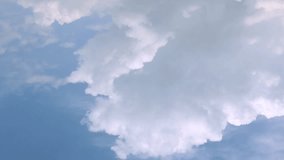 Aerial view time lapse video of white fluffy cumulus clouds against blue sky. Very beautiful fluffy, puffy cloudscape, FHD.