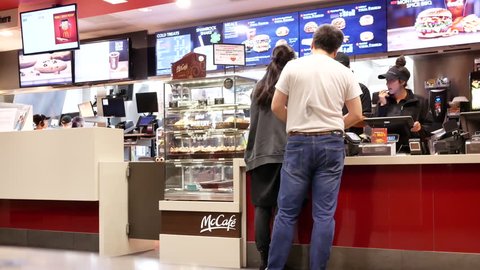 Coquitlam, BC, Canada - March 10, 2018 : Fast motion of people line up for ordering food at Mcdonalds check out counter with 4k resolution