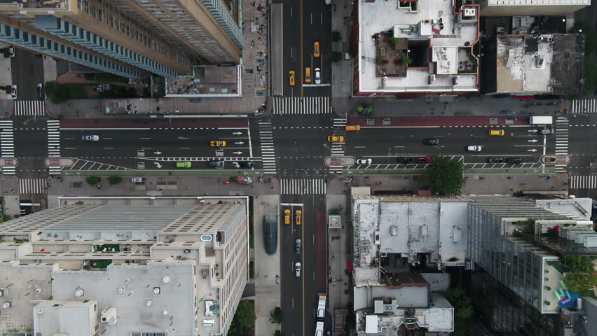 overhead aerial cars driving in Midtown Manhattan traffic New York City NYC centered 4K and 1080 HD