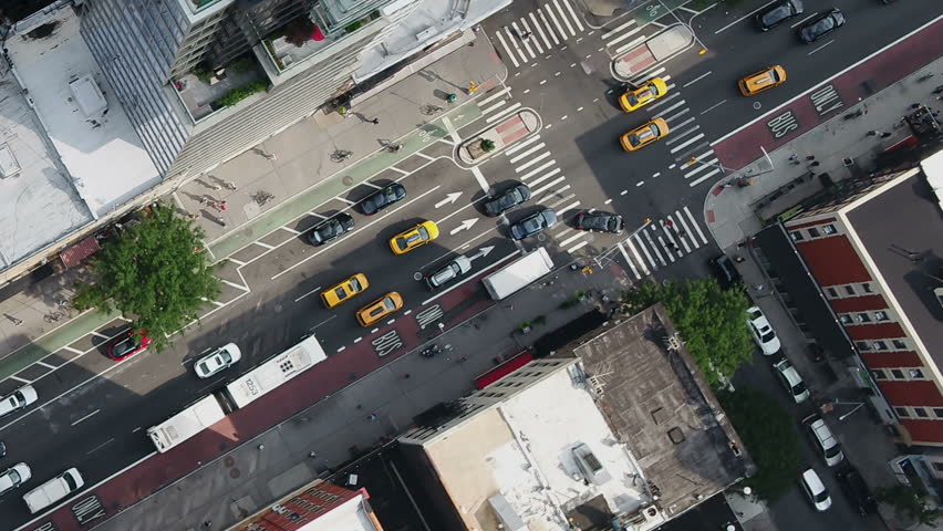 Overhead aerial diagonal cars driving in Midtown Manhattan traffic New York City NYC 1080 HD