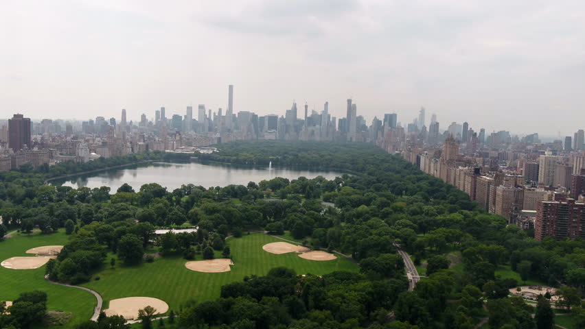 Central Park aerial pulling back over meadow New York City NYC 4K and 1080 HD