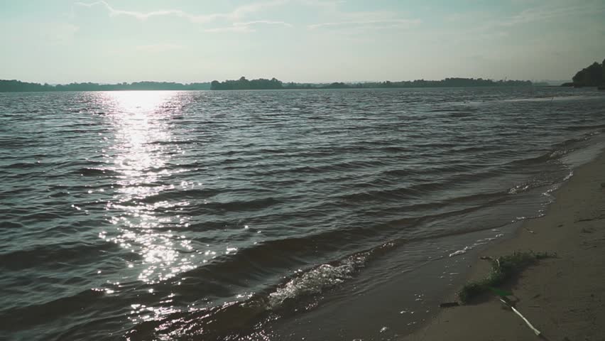 Young guys and girls happily run into the river