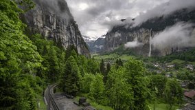 Landscape of Swiss Alps Lauterbrunnen valley in Switzerland, Europe in summer. Beautiful classic nature scenery from Bernese Oberland with mountains Jungfrau Timelapse of mountains and waterfall 