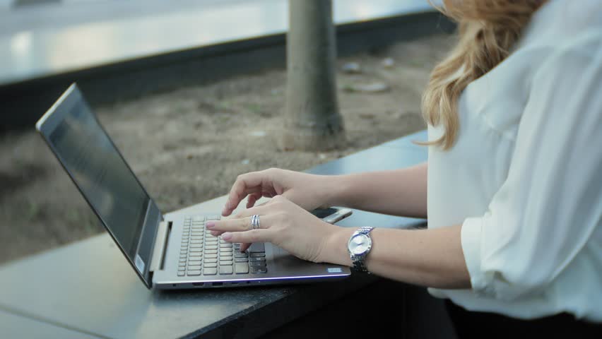 Young businesswoman working on laptop in city park business center 4k | Shutterstock HD Video #1015639882
