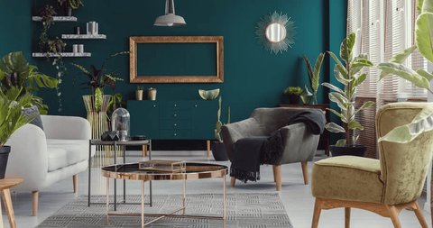 Video of green living room interior with plants with furniture like copper table, armchairs and sofa disappearing