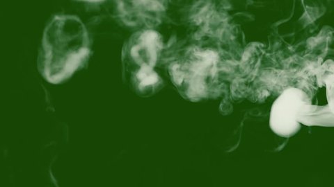 White steam or smoke flies in portions. isolated green screen for easy overlay in video editor