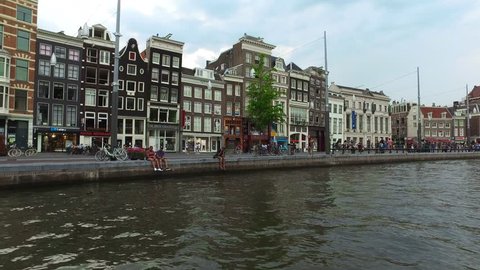 Amsterdam  / Netherlands - August 7 2018: Urban Life From Tourist Boat Sail Through The Canals of Amsterdam Netherlands 