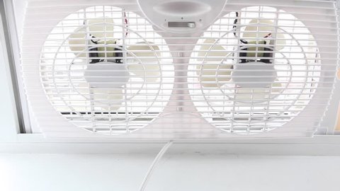 A dual sided white fan showing one side slowing down and stopping movement.  Arkivvideo