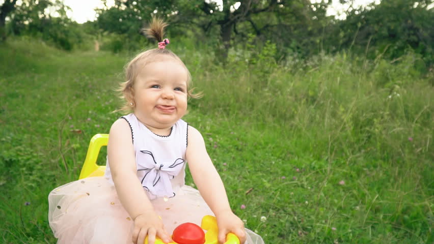 the little girl is riding a typewriter