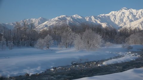 Frozen river and snowy field in winter. Hakuba village in Nagano prefecture Japan