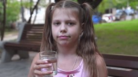girl drinking still water from glass