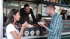 Couple tourists enjoy eating pasta from food truck at outdoor market - Powered by Shutterstock - Get 15% off with code: PIKWIZARD15