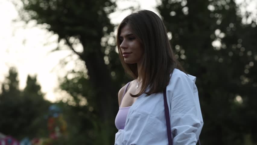 Happy woman in a park enjoying summer holidays