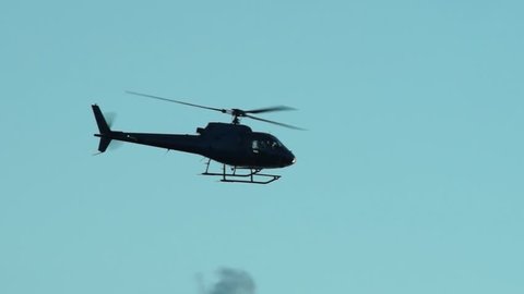 helicopter flying in the sky at dusk
