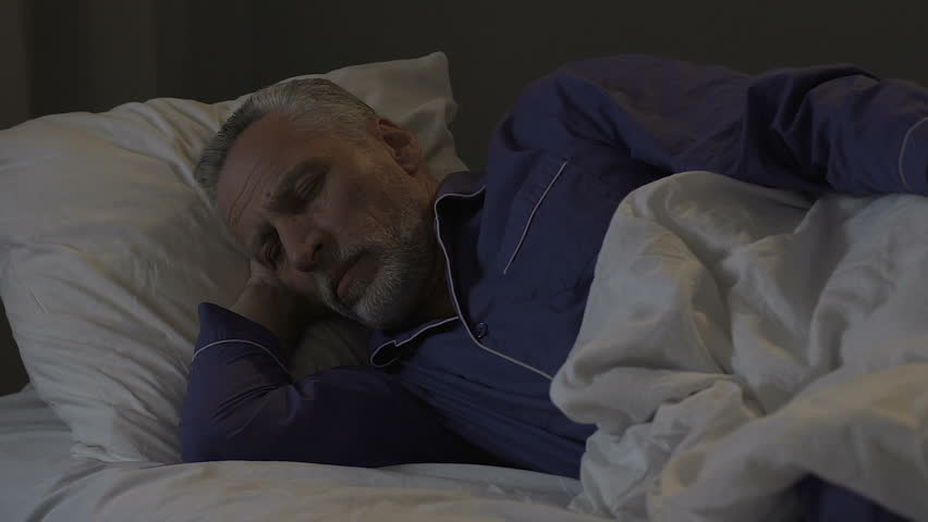Elderly man lying in bed at night unable to sleep, insomnia, disturbing thoughts Royalty-Free Stock Footage #1015698526