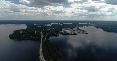 Tilt / panning up to see the city of Punkaharju and the mill, narrow road with lakes on both sides