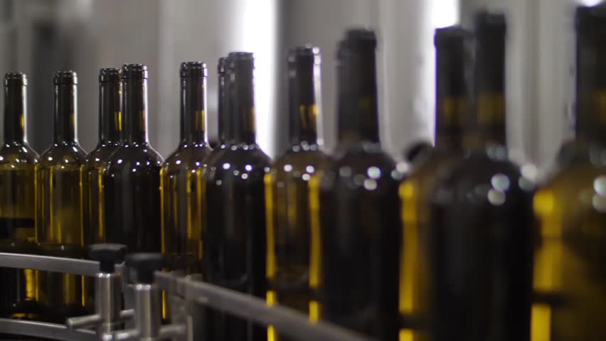 Wine bottles in conveyor belt  bottling line industry slow motion | Shutterstock HD Video #1015701958