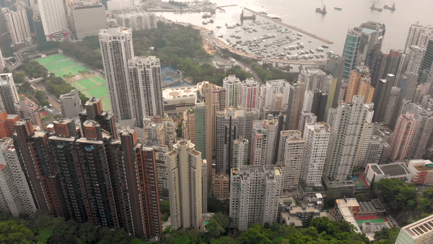 Aerial drone shot of Hong Kong city from Braemar hill viewpoint reveal residential area, office building and the pier