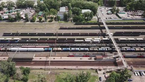 Aerial drone footage view trains with cargo moving on lifting railroad panorama transportation in the city Moscow Russia