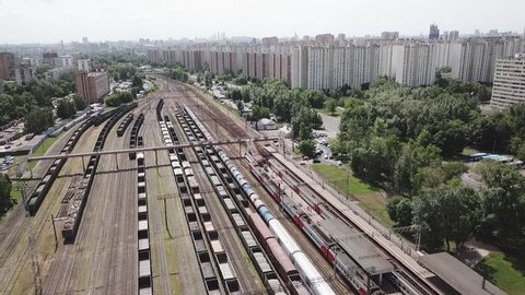 Aerial drone footage view trains with cargo moving on lifting railroad panorama transportation in the city Moscow Russia