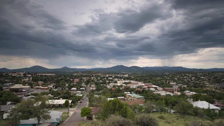 Summer monsoon storms pass over a small mountain town in the desert
