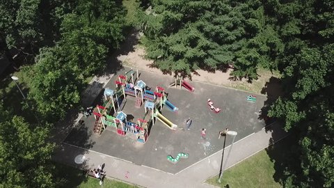 Aerial view of children with parents on playground in park outside playing games with chalk drawings in Moscow Russia