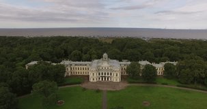 4K cloudy day aerial drone video of beautiful vintage architecture of Znamenka Estate, green park and palace near Peterhof center, in the suburbs of Saint Petersburg, the Russia's northern capital