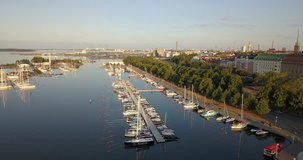4K summer early morning aerial video of Helsinki Baltic Sea Finnish Bay lagoon, Merisatama boat parking yacht club area, boats, calm water surface in the capital of Finland Suomi, northern Europe