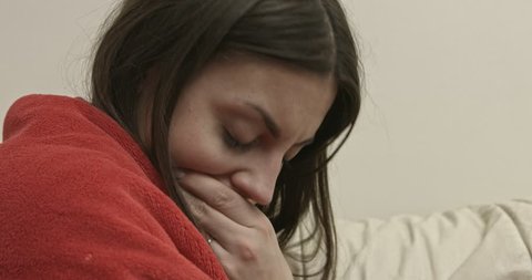 Young woman having nausea. she is ill or pregnant. The camera is focus on her face and bring closer.