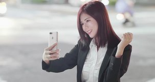 woman take phone and selfie happily in city at night