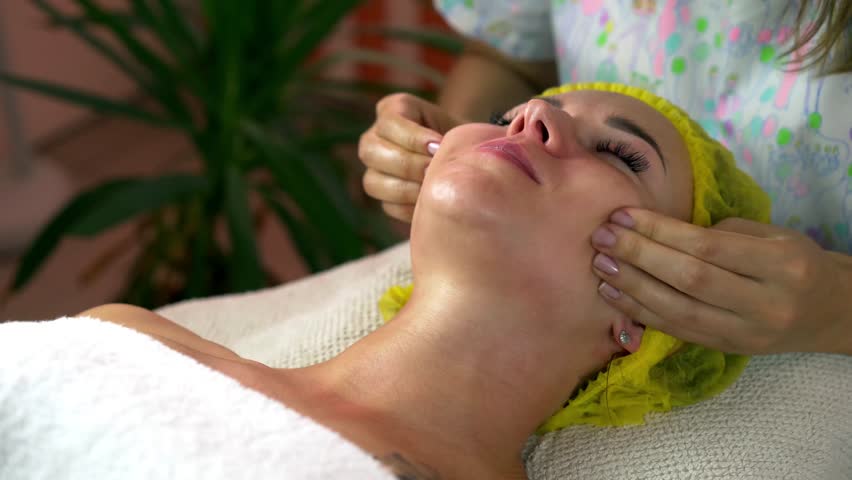 Girl having facial massage. Removes the second chin, corrects ptosis
