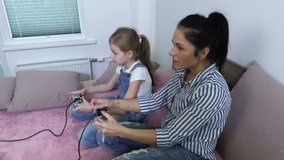 Happy mother and daughter enjoy game