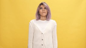Confused woman in warm cardigan dont having idea over yellow background