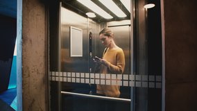 Young confident woman enters elevator, pushes button, door closes and she rides down using smartphone mobile office app. - Powered by Shutterstock - Get 15% off with code: PIKWIZARD15