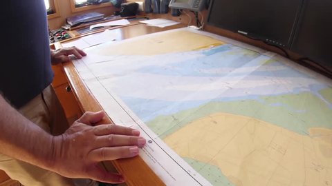 sailor reading nautical chart map ship boat slow motion