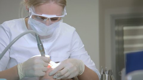 Dentist Is Treating Patient In Modern Dental Office