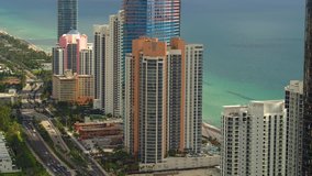 Aerial Florida beachfront realty luxury highrises Miami Dade 4k 24p